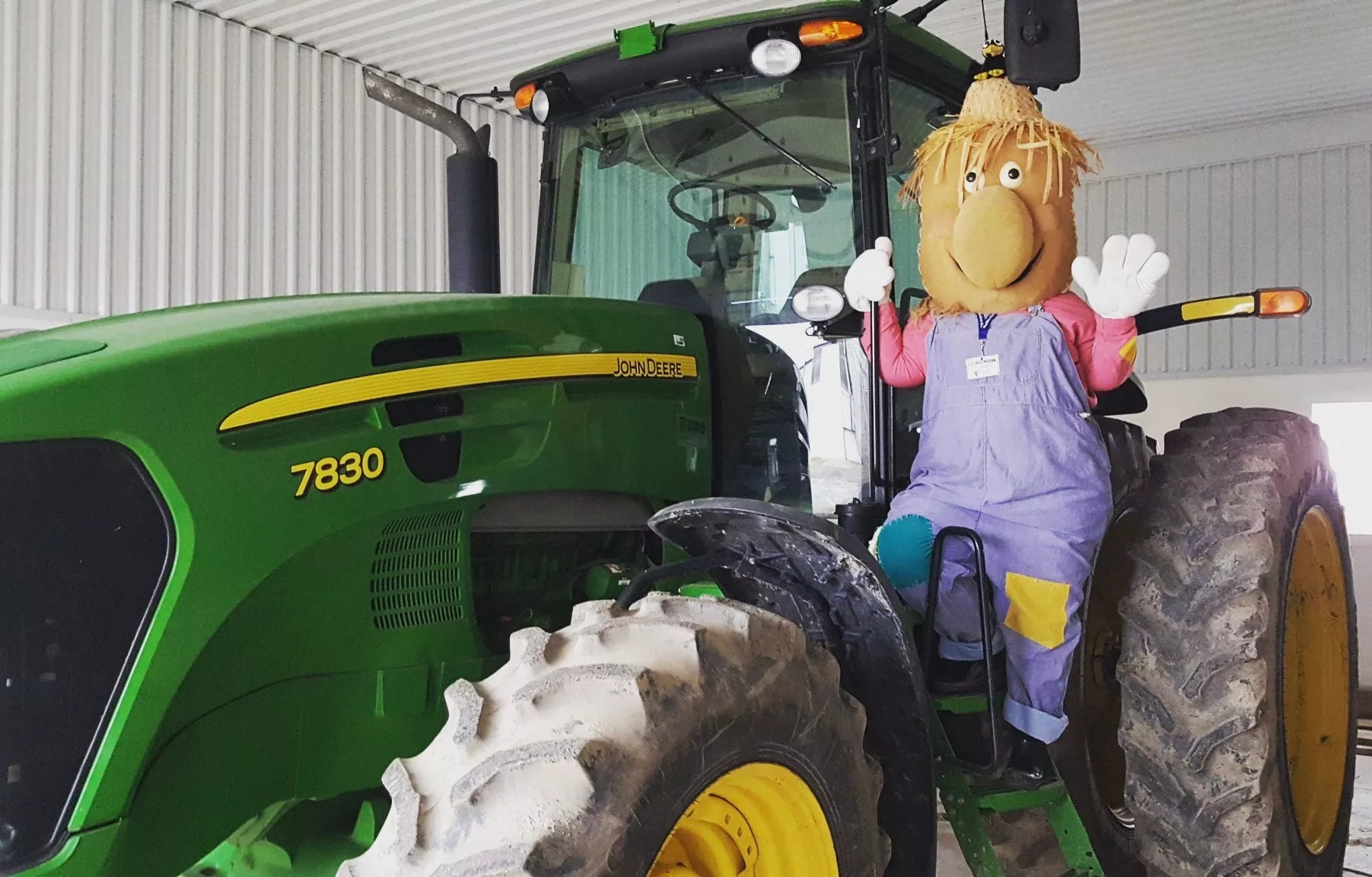 A scarecrow sitting on a tractor