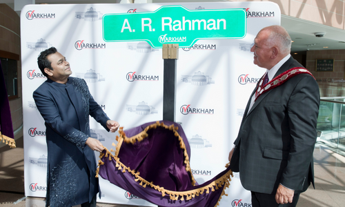 Mayor Frank Scarpitti and A.R. Rahman reveal future street sign at Markham Civic Centre.